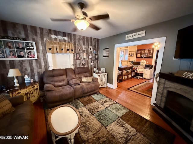 living area with ceiling fan and wood finished floors