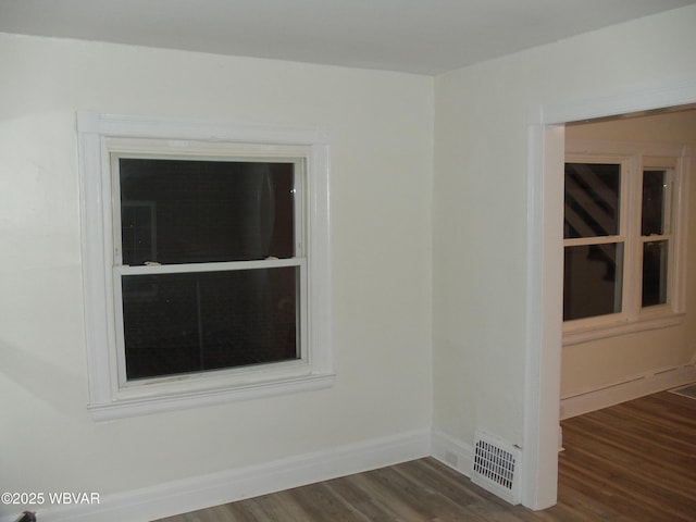 spare room with dark hardwood / wood-style floors