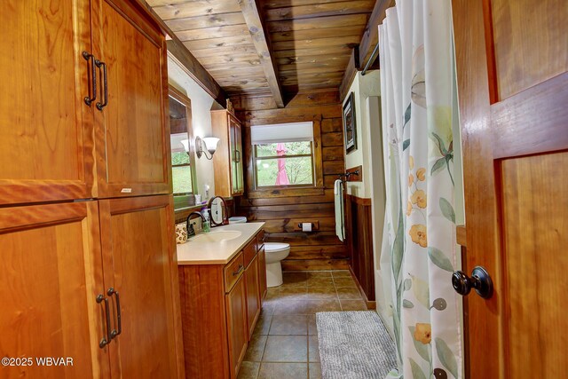 1640 Pleasant Valley Rd, Cogan Station, PA 17728 - full bathroom featuring wooden ceiling with exposed beams, vanity, toilet, tile patterned flooring, and wood walls
