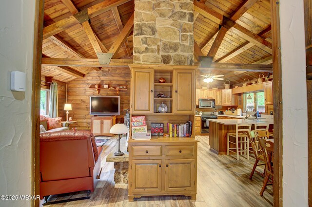 1640 Pleasant Valley Rd, Cogan Station, PA 17728 - living area featuring wood ceiling with exposed beams, light wood-style floors, wood walls, a ceiling fan, and high vaulted ceiling