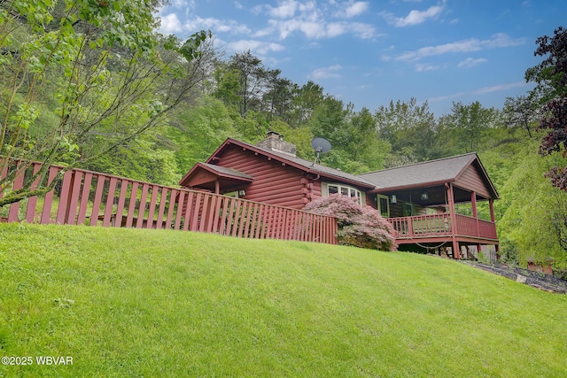 1640 Pleasant Valley Rd, Cogan Station, PA 17728 - back of house featuring a chimney, a yard, log siding, and a wooden deck