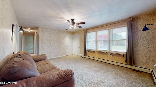 carpeted living room featuring baseboard heating and ceiling fan