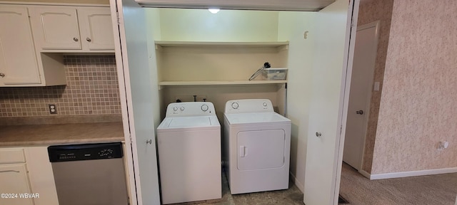 clothes washing area with washing machine and dryer