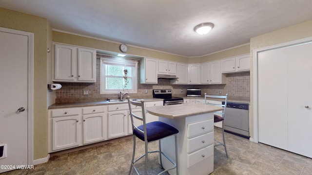 kitchen featuring a breakfast bar, a center island, white cabinetry, and stainless steel appliances