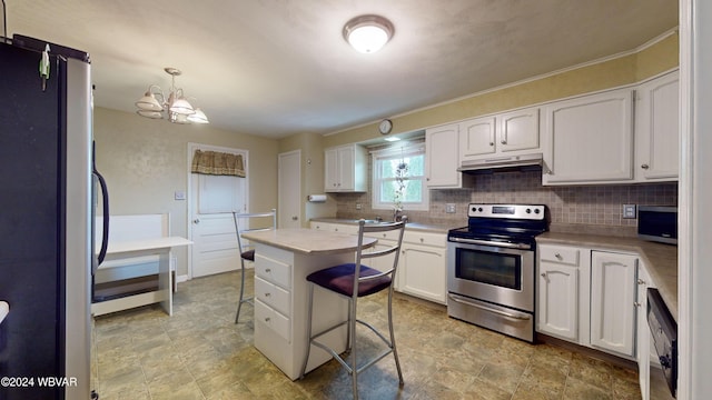 kitchen featuring pendant lighting, a center island, white cabinets, appliances with stainless steel finishes, and a breakfast bar area