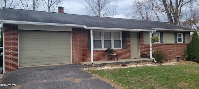 ranch-style house with a garage and a front lawn