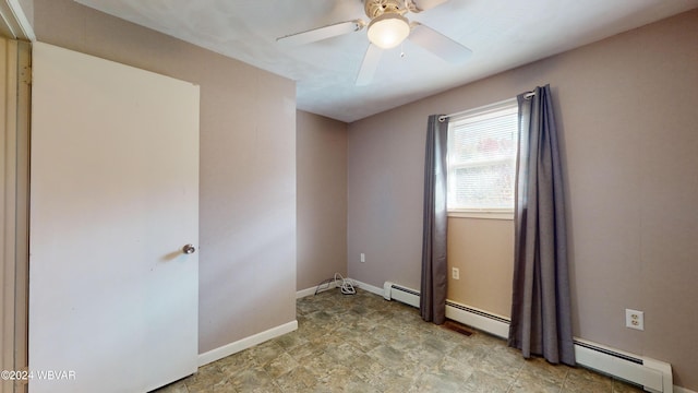 spare room featuring a baseboard radiator and ceiling fan