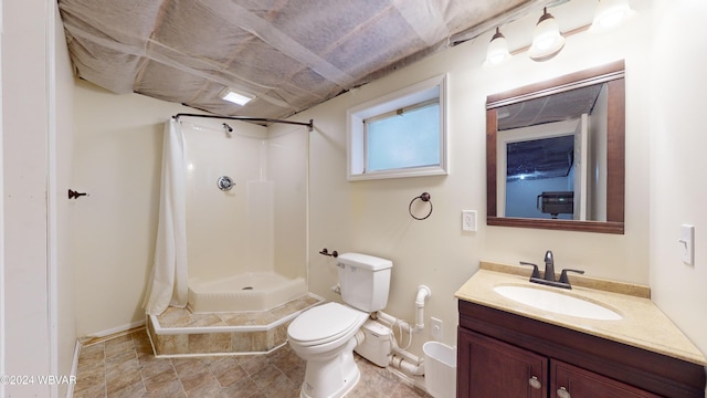 bathroom with vanity, toilet, and walk in shower