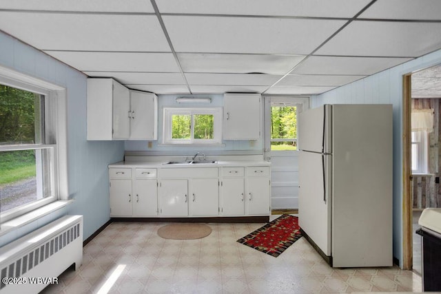 1462 Highland Lake Rd, Hughesville, PA 17737 - kitchen with freestanding refrigerator, radiator heating unit, a sink, light countertops, and white cabinets