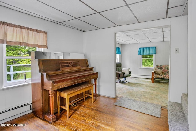 1462 Highland Lake Rd, Hughesville, PA 17737 - sitting room with a baseboard heating unit, a drop ceiling, and wood-type flooring