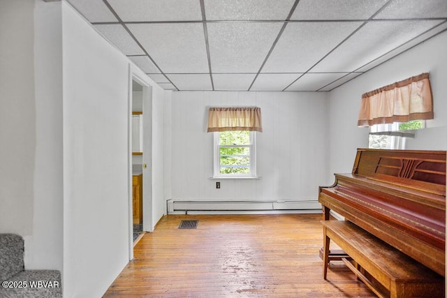 1462 Highland Lake Rd, Hughesville, PA 17737 - living area featuring a paneled ceiling, a baseboard heating unit, and wood-type flooring