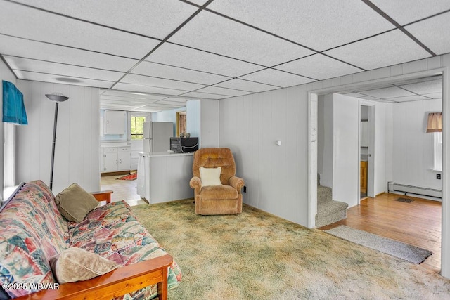 1462 Highland Lake Rd, Hughesville, PA 17737 - living area featuring a paneled ceiling, a baseboard radiator, light wood finished floors, and stairway