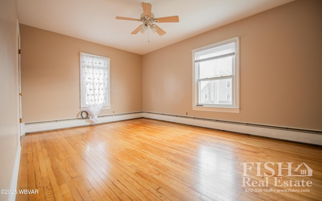 unfurnished room featuring ceiling fan, wood-type flooring, and a baseboard radiator