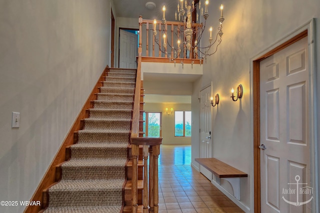 2312 Teaberry Ln, Lock Haven, PA 17745 - stairs with a towering ceiling, tile patterned flooring, a chandelier, and baseboards