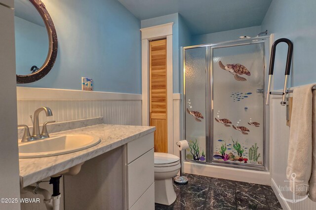 2312 Teaberry Ln, Lock Haven, PA 17745 - full bath featuring a sink, a stall shower, toilet, marble finish floor, and wainscoting