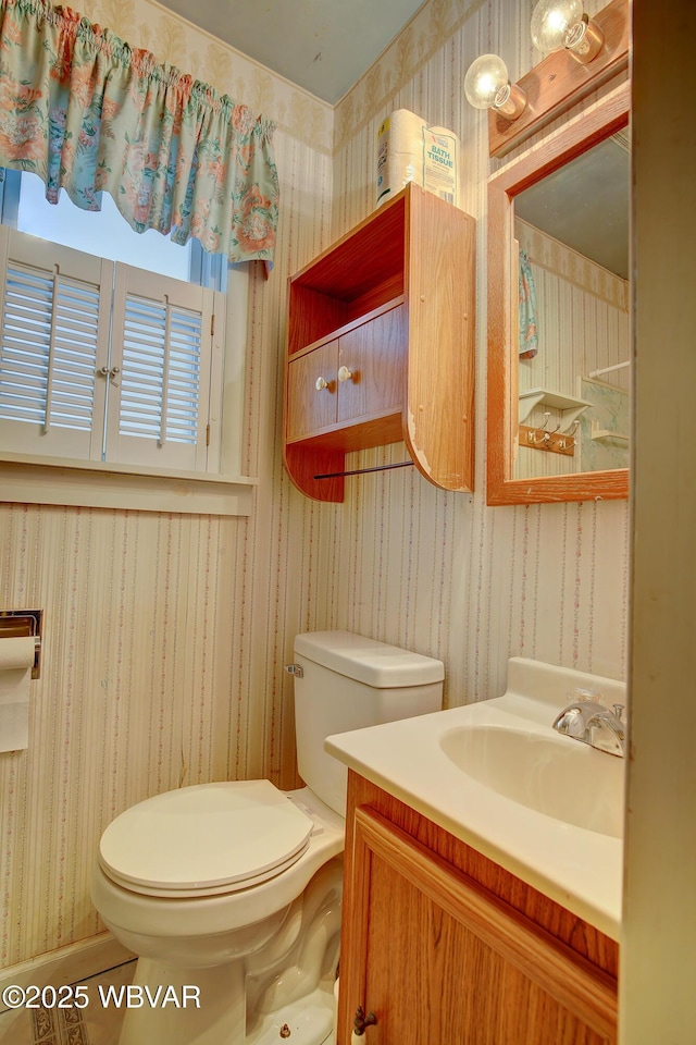 bathroom featuring vanity, tile patterned flooring, and toilet