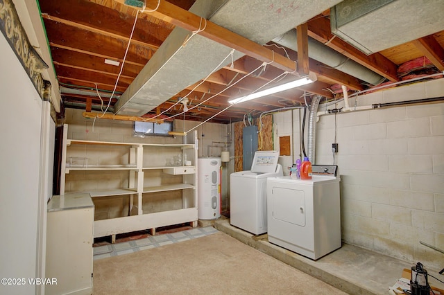 basement featuring independent washer and dryer, electric panel, and electric water heater