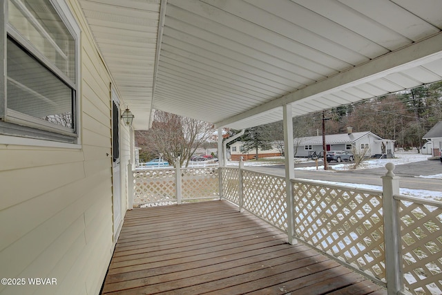 snow covered deck with a porch