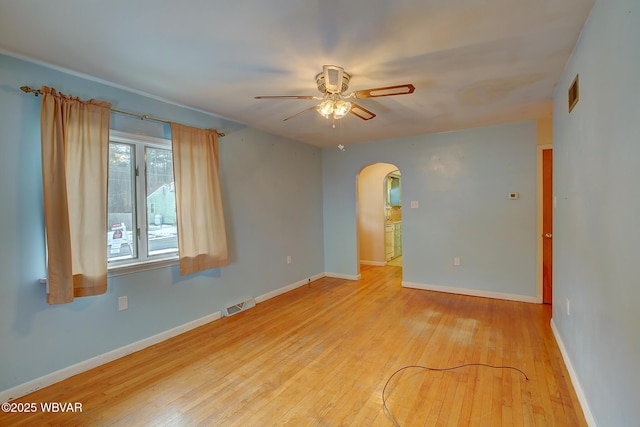 empty room featuring hardwood / wood-style flooring and ceiling fan