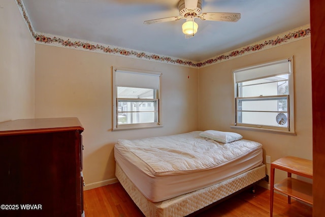 bedroom featuring light hardwood / wood-style flooring and ceiling fan