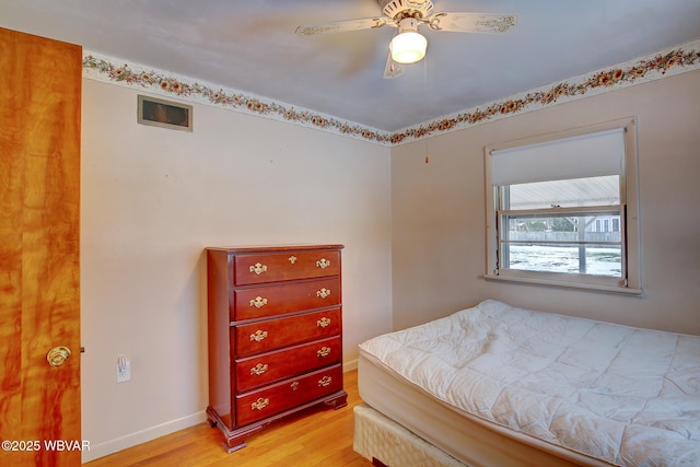 bedroom with ceiling fan and light hardwood / wood-style flooring