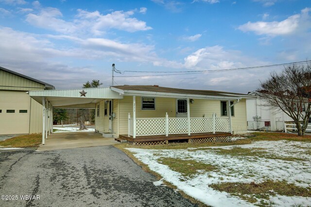 view of front of property with a carport and covered porch