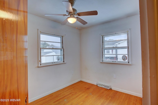 empty room with ceiling fan and light wood-type flooring