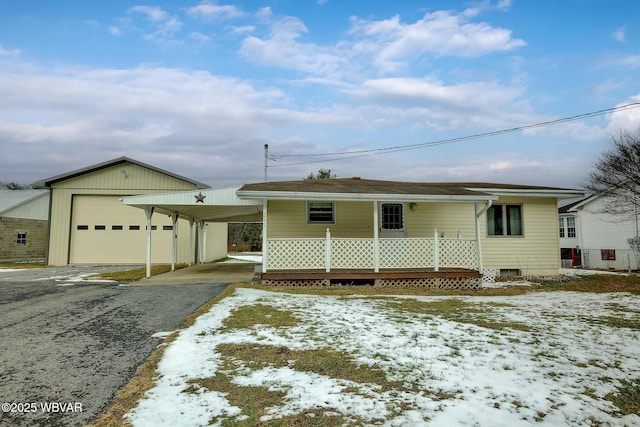 view of front facade featuring a carport, a garage, and covered porch