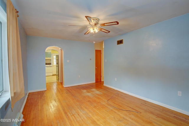 spare room featuring ceiling fan and light hardwood / wood-style flooring