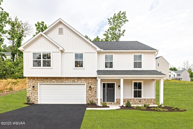 view of front facade featuring a porch, a garage, and a front lawn