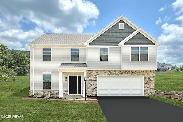 view of front of property featuring a garage and a front lawn