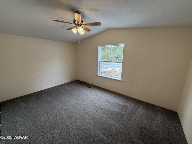 unfurnished room featuring lofted ceiling, carpet, a textured ceiling, and ceiling fan