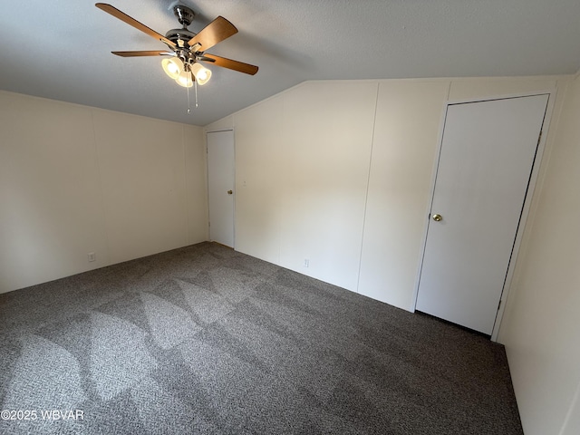 bonus room featuring dark carpet, ceiling fan, and lofted ceiling