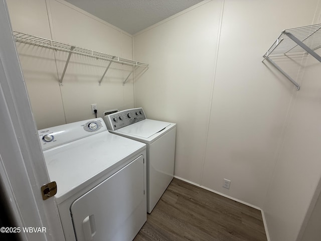 laundry room featuring dark hardwood / wood-style floors and washing machine and clothes dryer