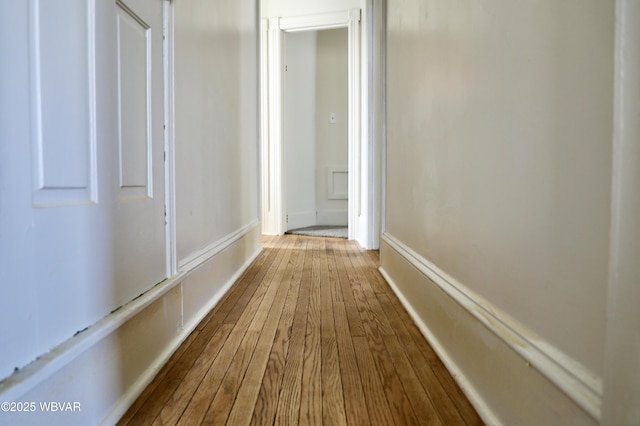 corridor with hardwood / wood-style flooring