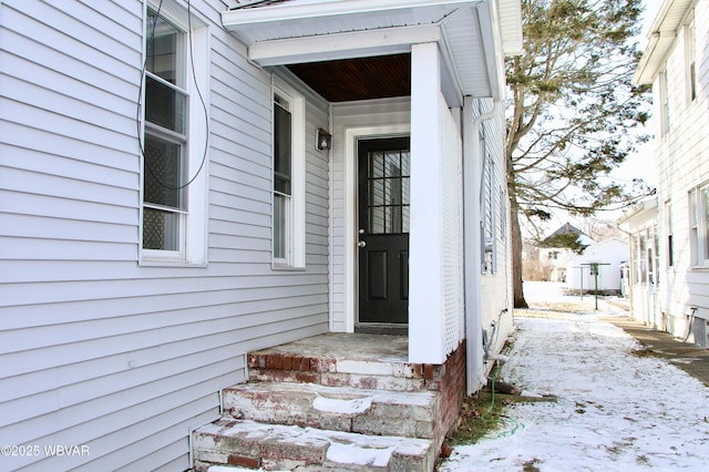 view of snow covered property entrance