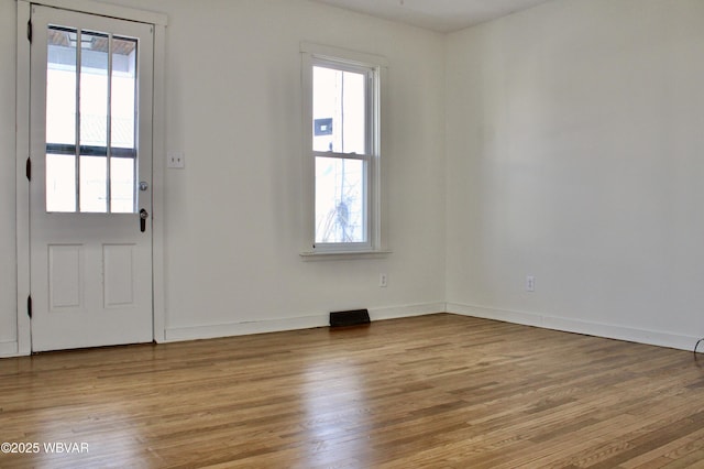 foyer entrance featuring plenty of natural light and light wood-type flooring