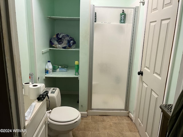 bathroom featuring toilet and an enclosed shower