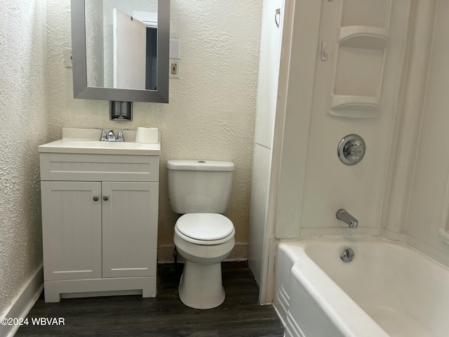 full bathroom with bathing tub / shower combination, vanity, hardwood / wood-style flooring, and toilet