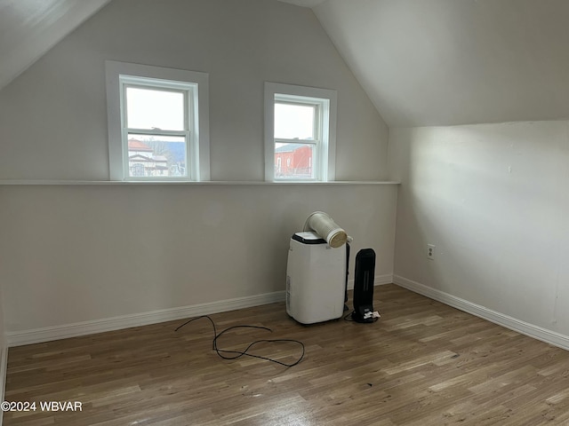 bonus room featuring vaulted ceiling and light hardwood / wood-style flooring