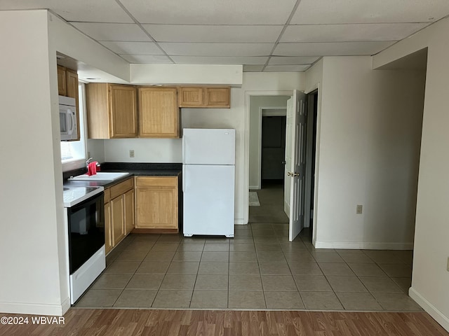 kitchen with a paneled ceiling, sink, dark hardwood / wood-style floors, and white appliances