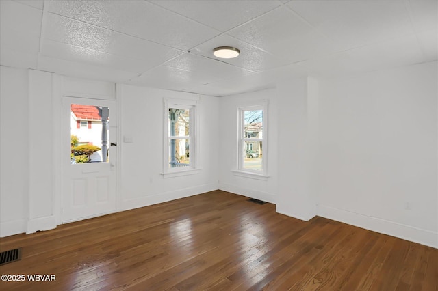 entrance foyer with a wealth of natural light, visible vents, and hardwood / wood-style floors