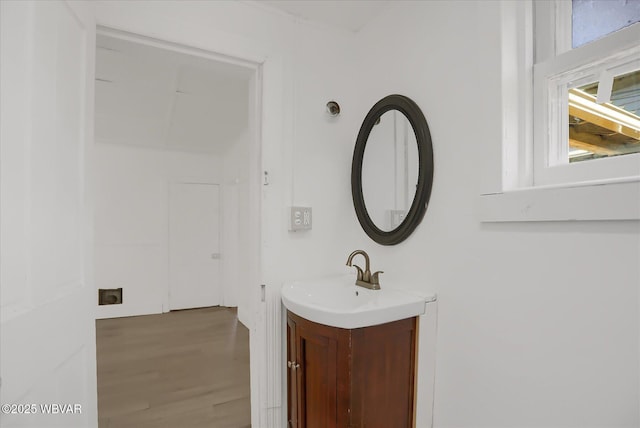 bathroom with wood finished floors and vanity