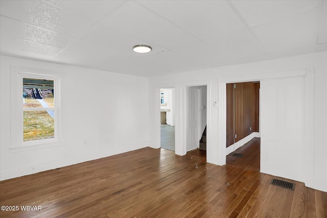 empty room featuring visible vents and wood finished floors