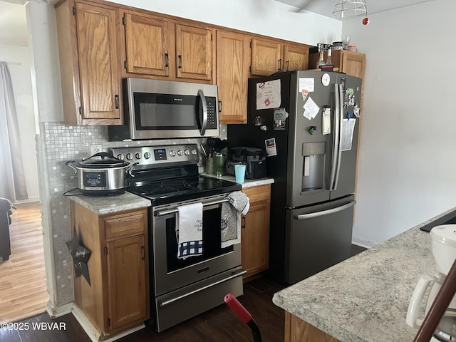 kitchen featuring backsplash, dark hardwood / wood-style floors, and appliances with stainless steel finishes