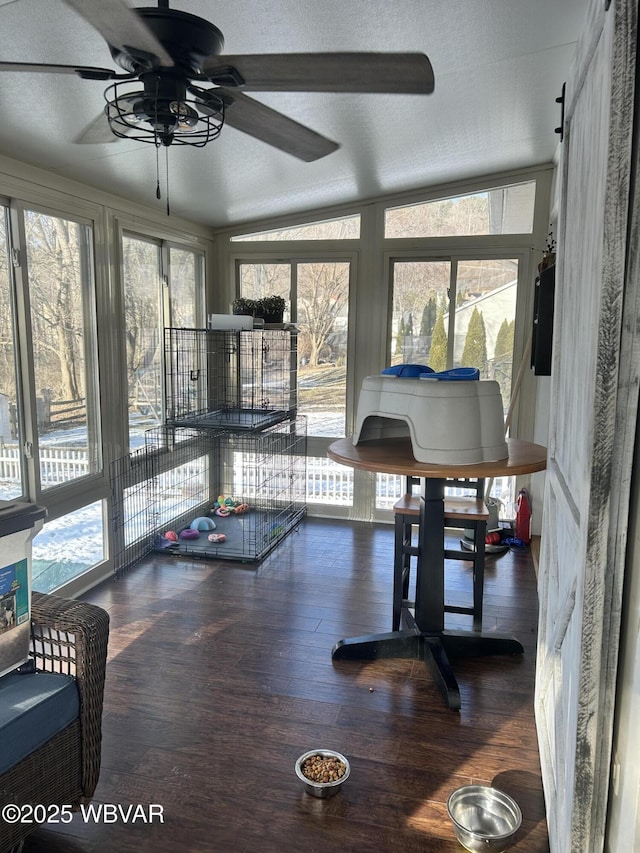 sunroom / solarium with ceiling fan and lofted ceiling