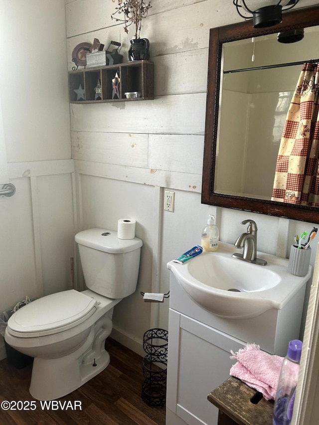 bathroom with vanity, hardwood / wood-style floors, and toilet