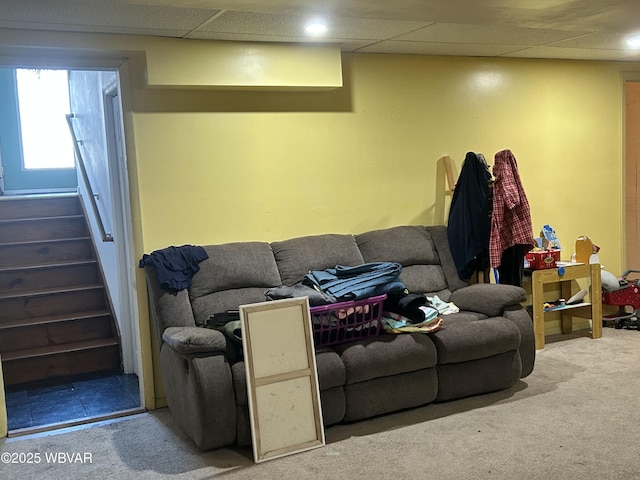 carpeted living room with a paneled ceiling