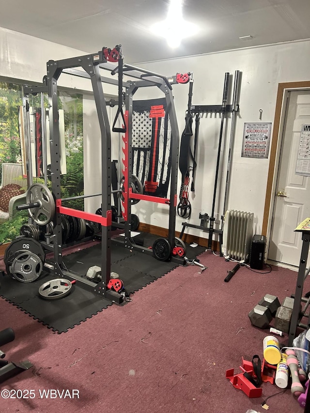 workout room featuring radiator heating unit