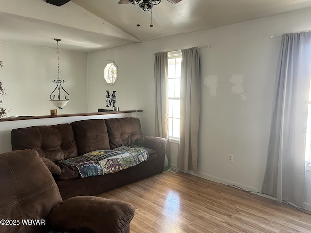 living room featuring vaulted ceiling, ceiling fan, and light hardwood / wood-style floors